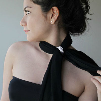 The Scarf Lock is the modern version of any scarf ring, scarf pin or scarf clips. The piece is made with a fine faux leather and available in many colors, and sizes: Size S (for silk & thin scarves), Size M (for regular scarves) and Size L (for bulky scarves). The closure consists of a Magnetic Clamp. All you do is insert a cylinder magnet (found on one side) to its open connection (on the other side) to lock and unlock. Finally, an easy and convenient way to wear scarves.